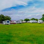 photo of rv sites and green grass field