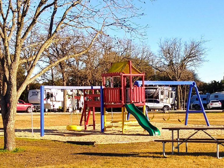 Photo of a playground with RV sites in background